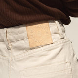 The paper tag of our sustainable jeans read Mindful Tomorrow