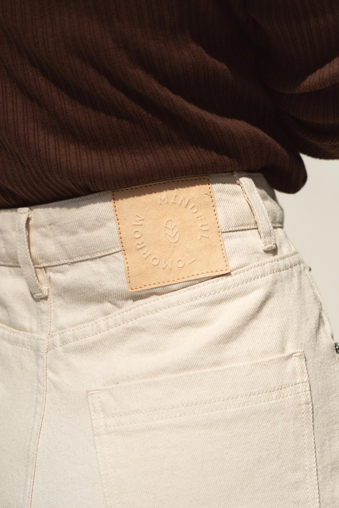 The paper tag of our sustainable jeans read Mindful Tomorrow